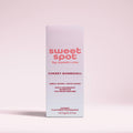 Sweet Spot by Sweetums Cherry Bombshell fragrance packaging on a light pink background