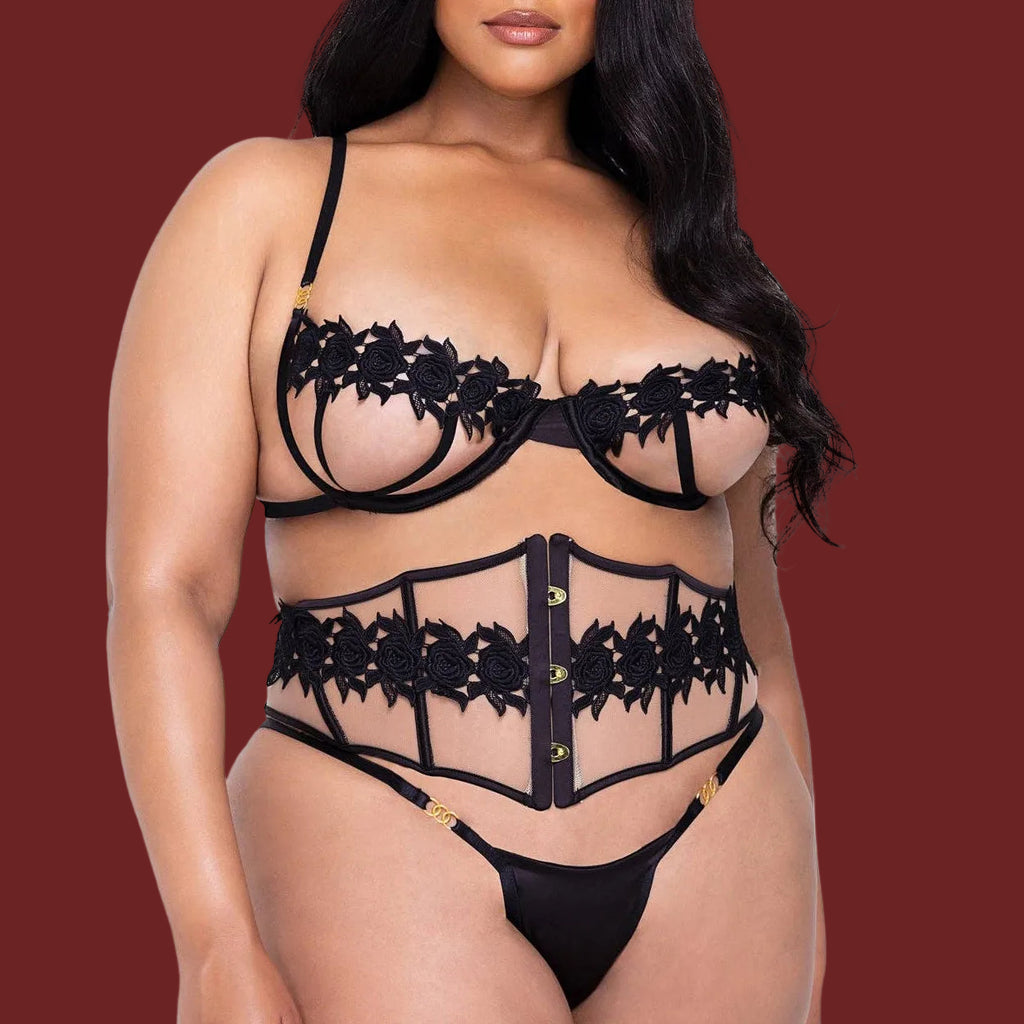 Woman wearing a black lace lingerie set on a white background