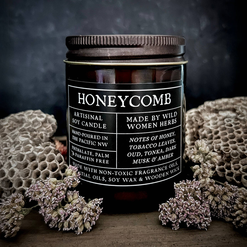 Honeycomb candle with a black label on a dark background