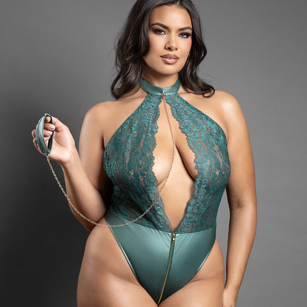Model wearing a green lace bodysuit against a gray background