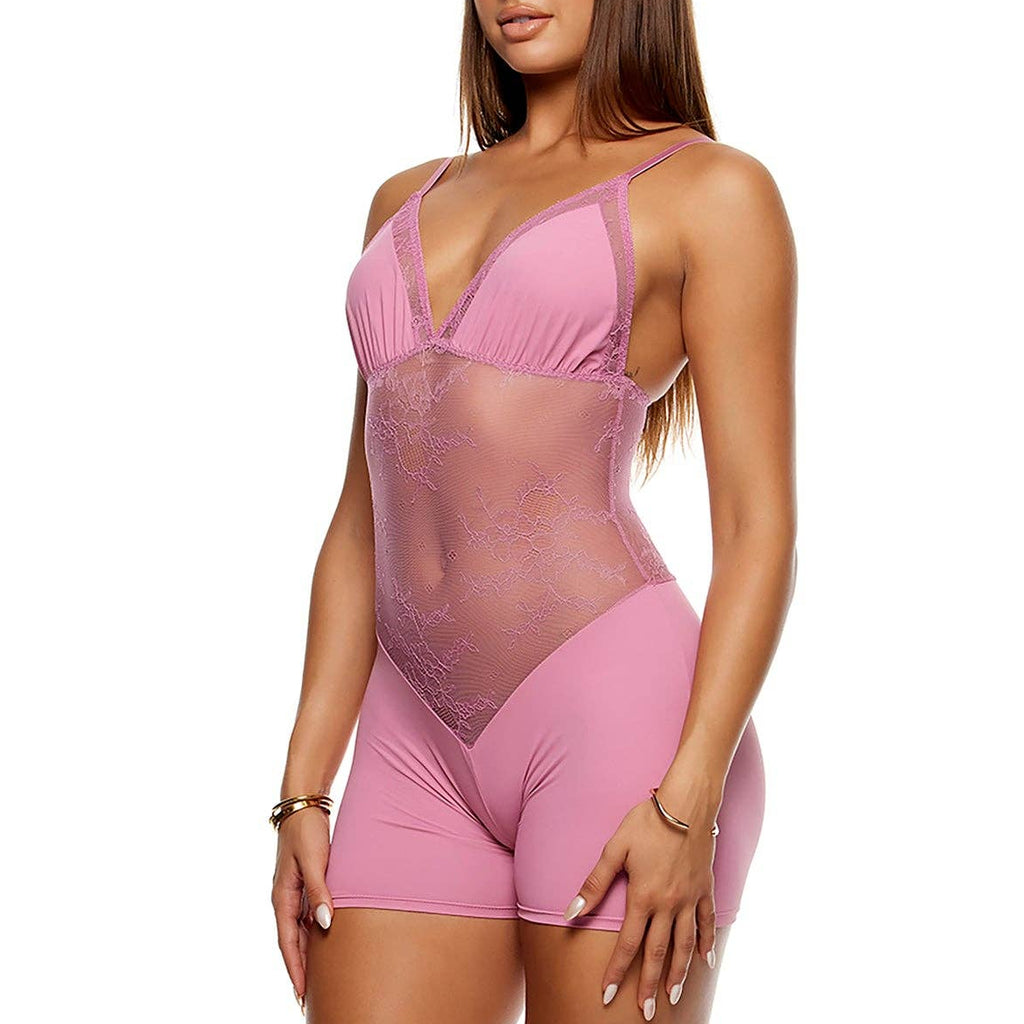 A woman modeling a pink lingerie set consisting of a sheer mesh bodysuit with a solid pink bra and matching shorts, paired with clear high-heeled platform sandals, against a plain white background.