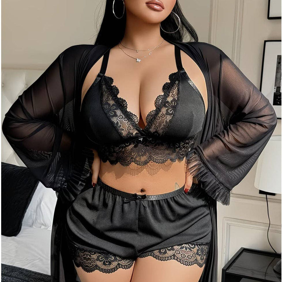 Woman wearing black lace lingerie set with sheer robe in a bedroom setting