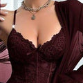 Burgundy lingerie set with matching robe against a white curtain background