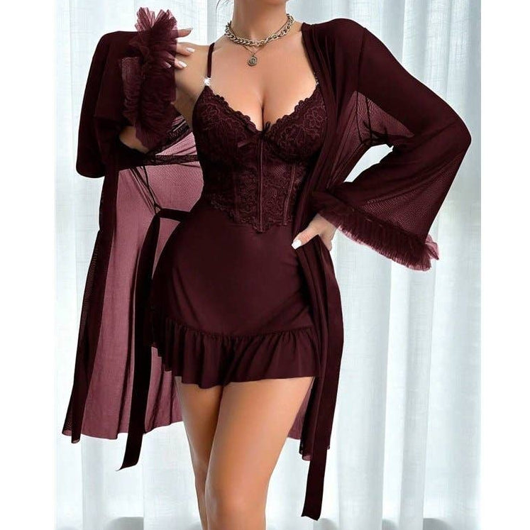 Burgundy lingerie set with matching robe against a white curtain background