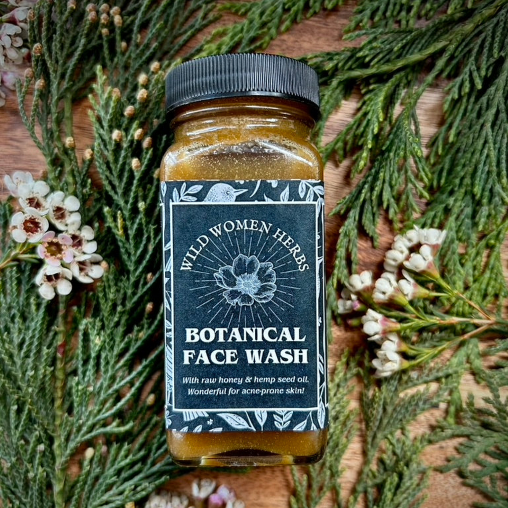 Jar of botanical face wash with a decorative label on a natural background
