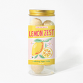 Jar of lemon-flavored sugar scrub with a yellow label on a white background