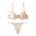 Beige bra and panties set on a white background