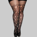 Black lace knee-high stockings worn with a black outfit on a white background