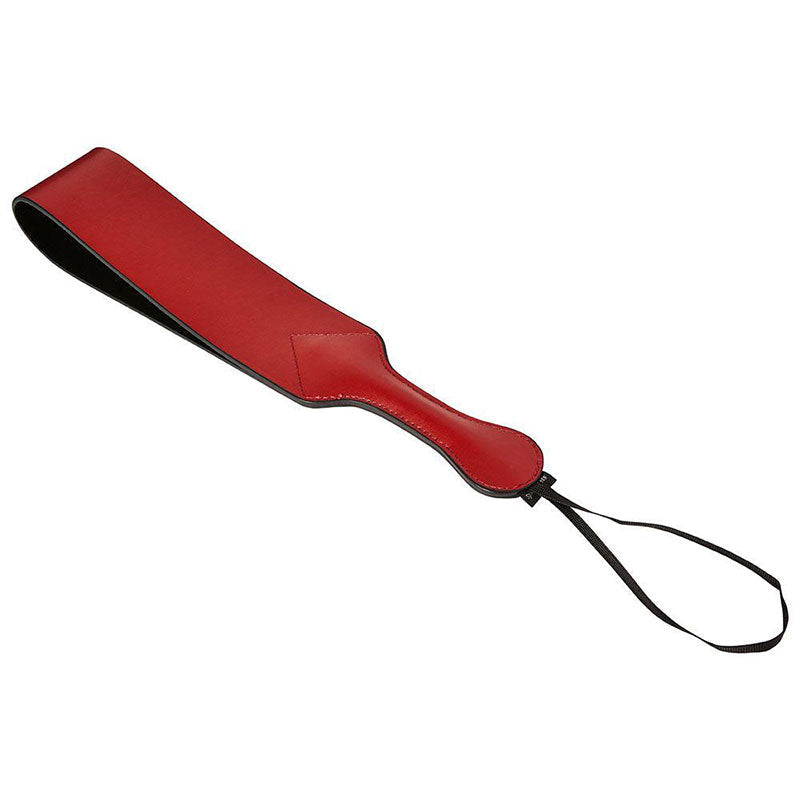 A long paddle with a folded over loop of faux leather.