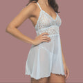 A woman modeling a light blue lace and sheer babydoll chemise nightgown against a plain white background.