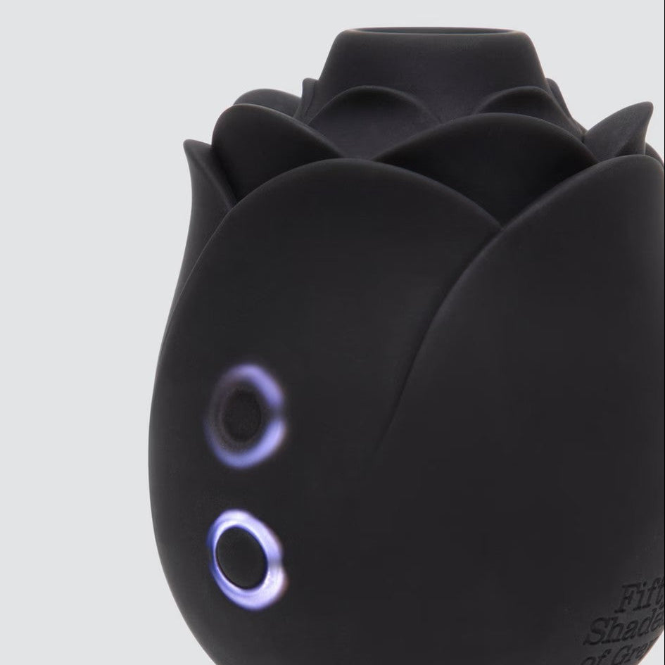 Black rose-shaped product with glowing eyes on a white background