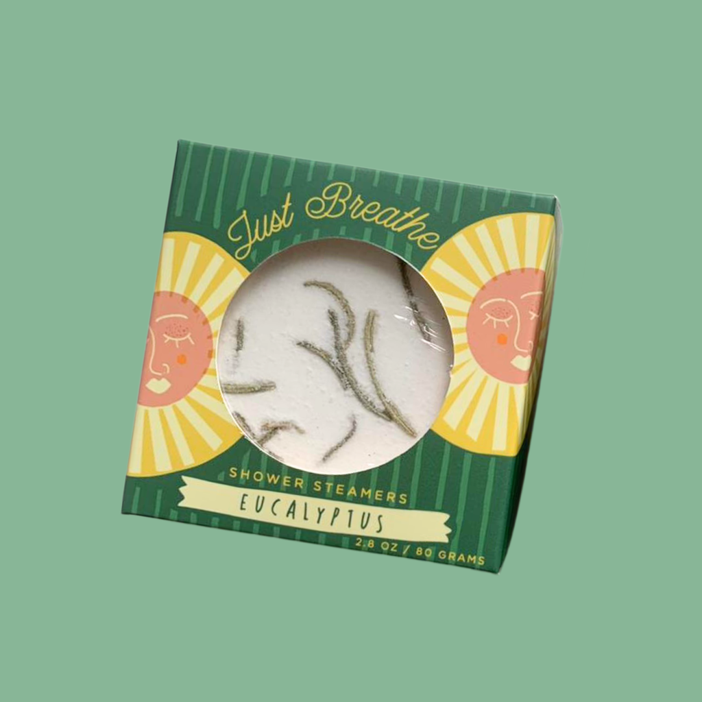 Shower steamers in a green box with 'Just Breathe' text on a green background