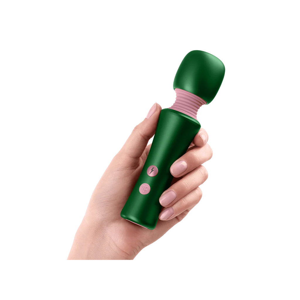 Hand holding a green handheld massager with pink accents on a white background