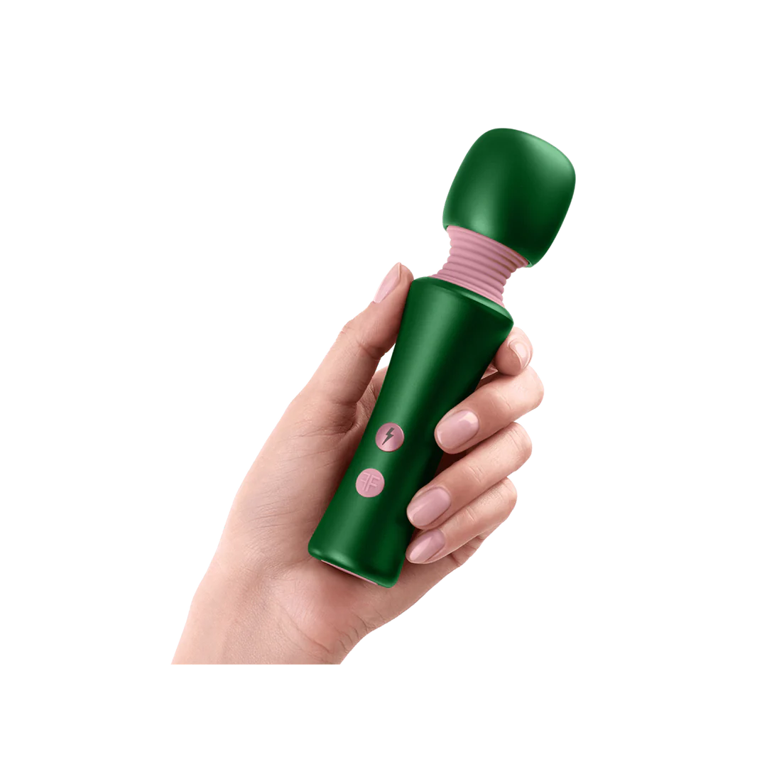 Hand holding a green handheld massager with pink accents on a white background