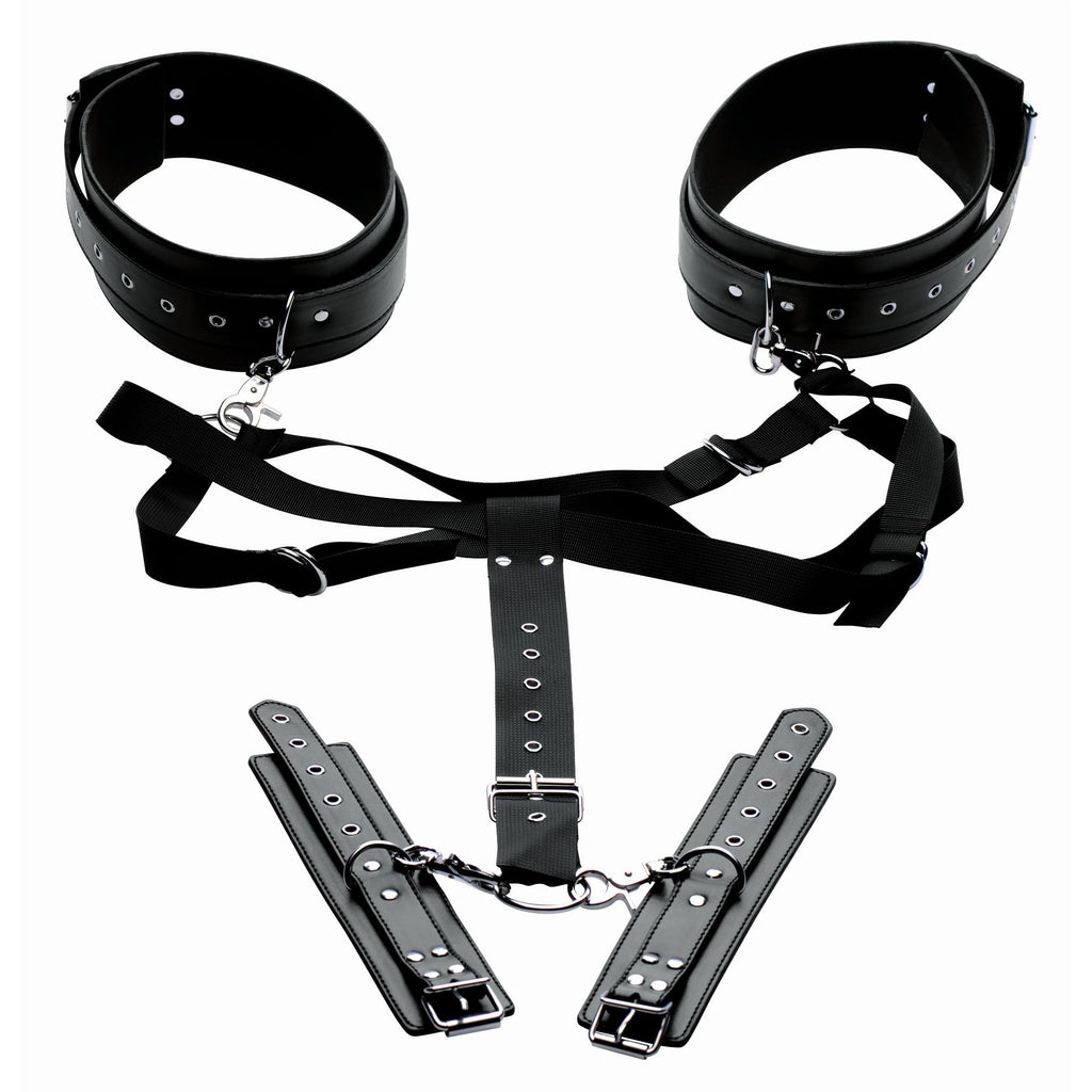 Black leather restraint set with cuffs, straps, and shackles on a white background