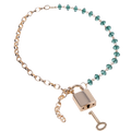A neck lace that where one half of the oval gold chain includes emerald green crystal beads and gold lock and key charm.
