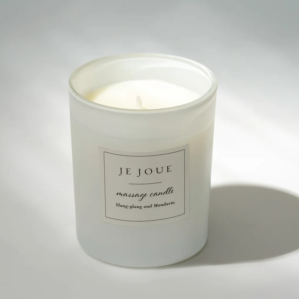 White candle with a label on a gray background