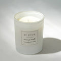 White candle with a label on a gray background