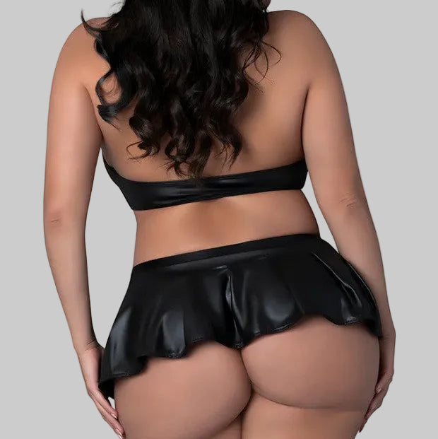 Model showing the back of the set. Bare shoulders and a very short skirt hitting above the cusp of her cheeks.