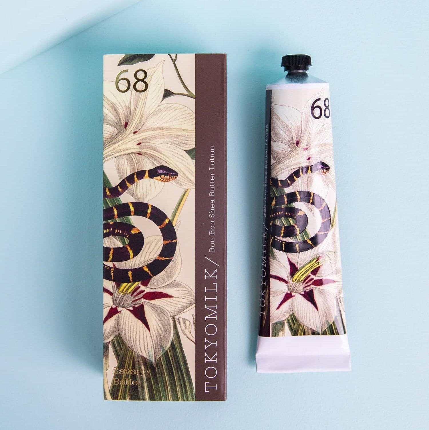 A 2.3 ounce tube of lotion adorned with an image of wisteria and a snake.