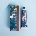 A tube of shea butter lotion adorned with a unicorn adrift in a blue galaxy.