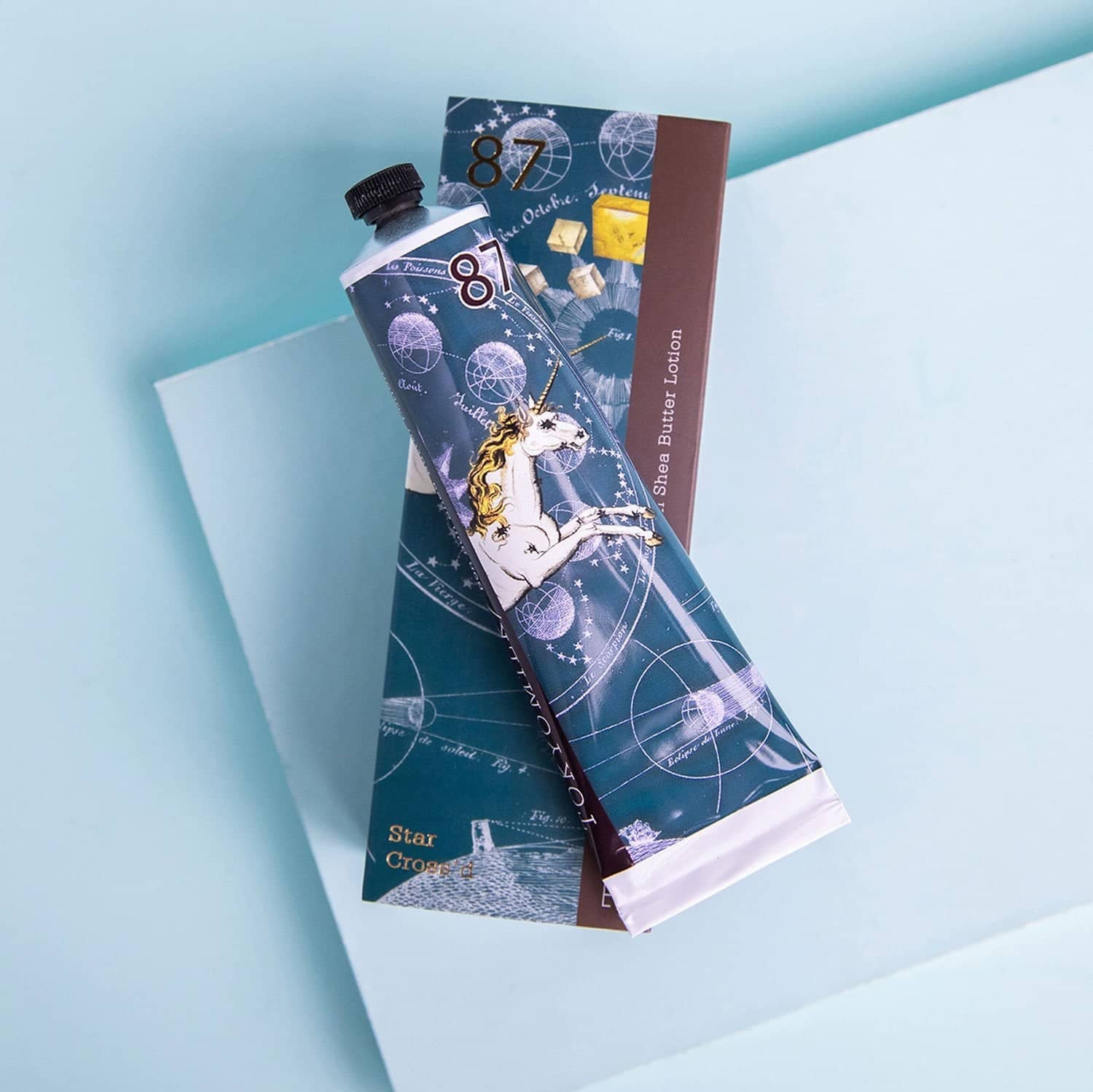 Unicorn-themed tube of toothpaste on a light blue background