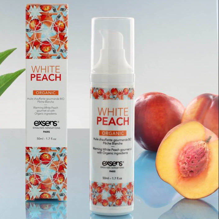 White Peach skincare product with packaging and peaches on a reflective surface
