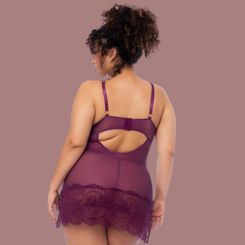 A model wearing a deep wine color babydoll with a long lace hem that covers her butt.