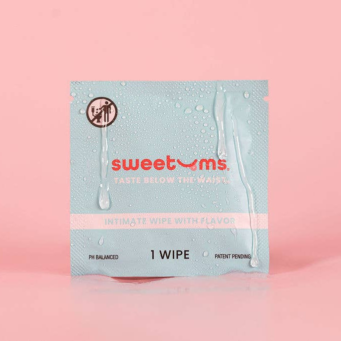 Sweetums wipe packaging on a pink background