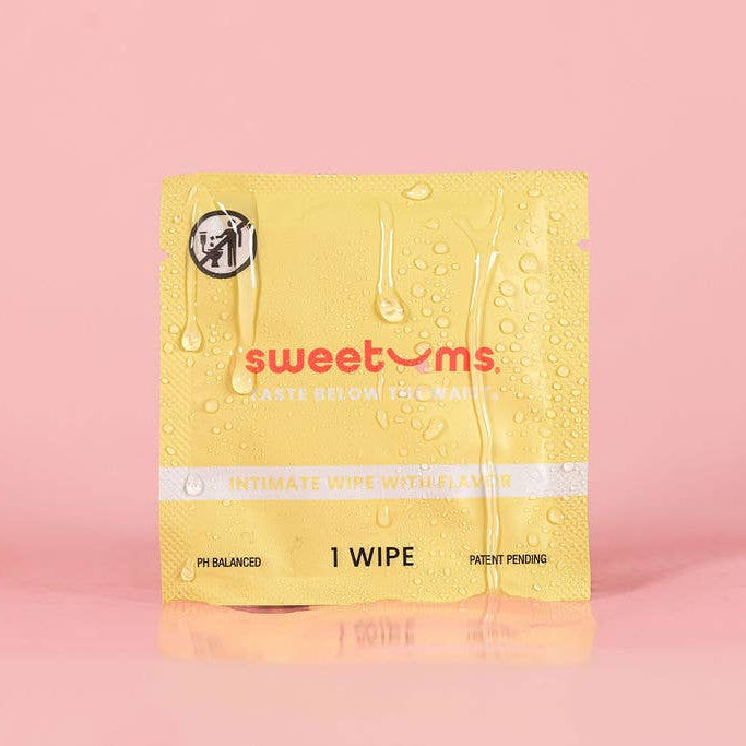 Yellow package of sweetums wipes on a pink background