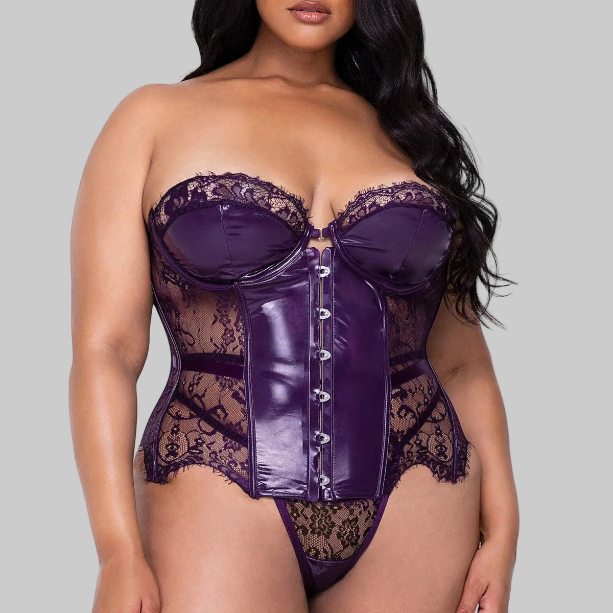 Woman wearing a purple lace lingerie set on a white background