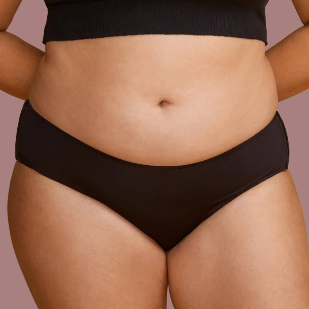 A plus-size model wearing a solid black panties that do not bind into her skin.