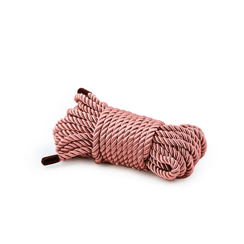 Pink rope coiled on a white background