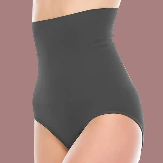 A close-up side view of a model wearing high-waisted black briefs or a shapewear panty against a plain white background.