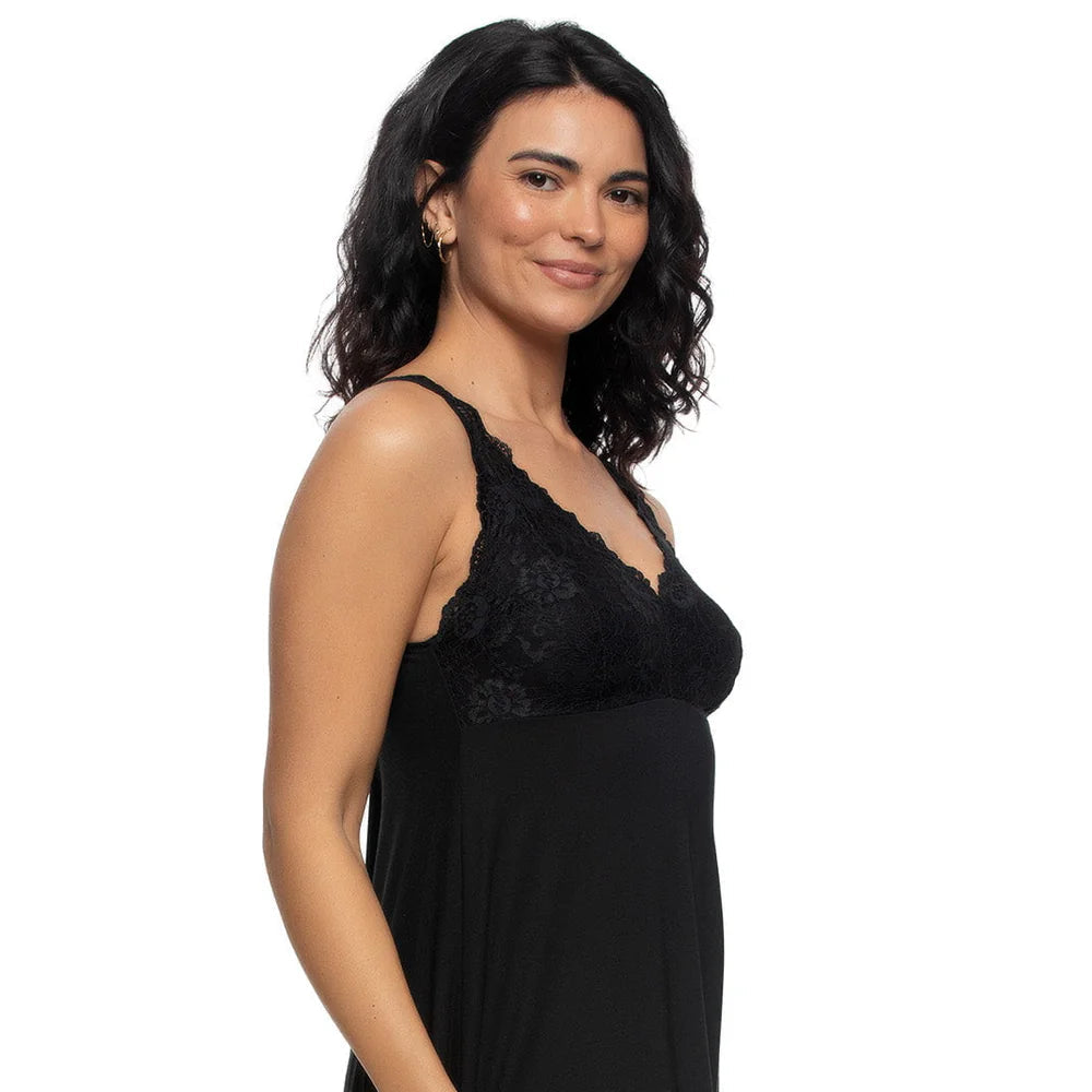 A woman modeling a black slip-style nightgown with a lace V-neck bodice and thin straps against a plain white background.