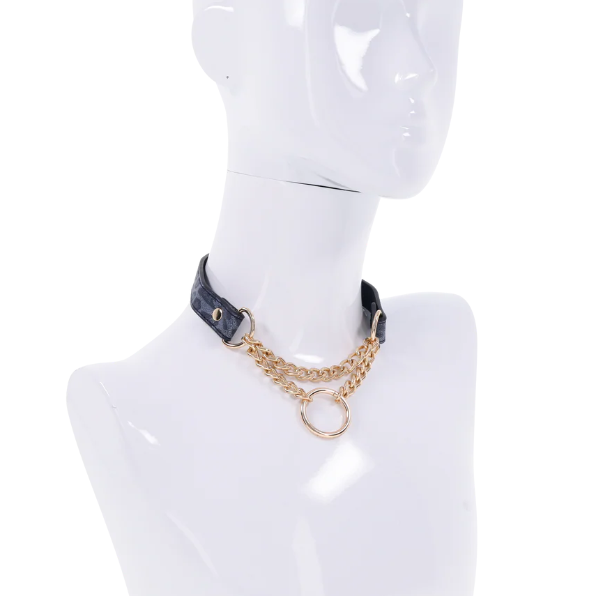 Deep blue and cougar print faux leather collar with gold chain at the collar bones and snap closure.