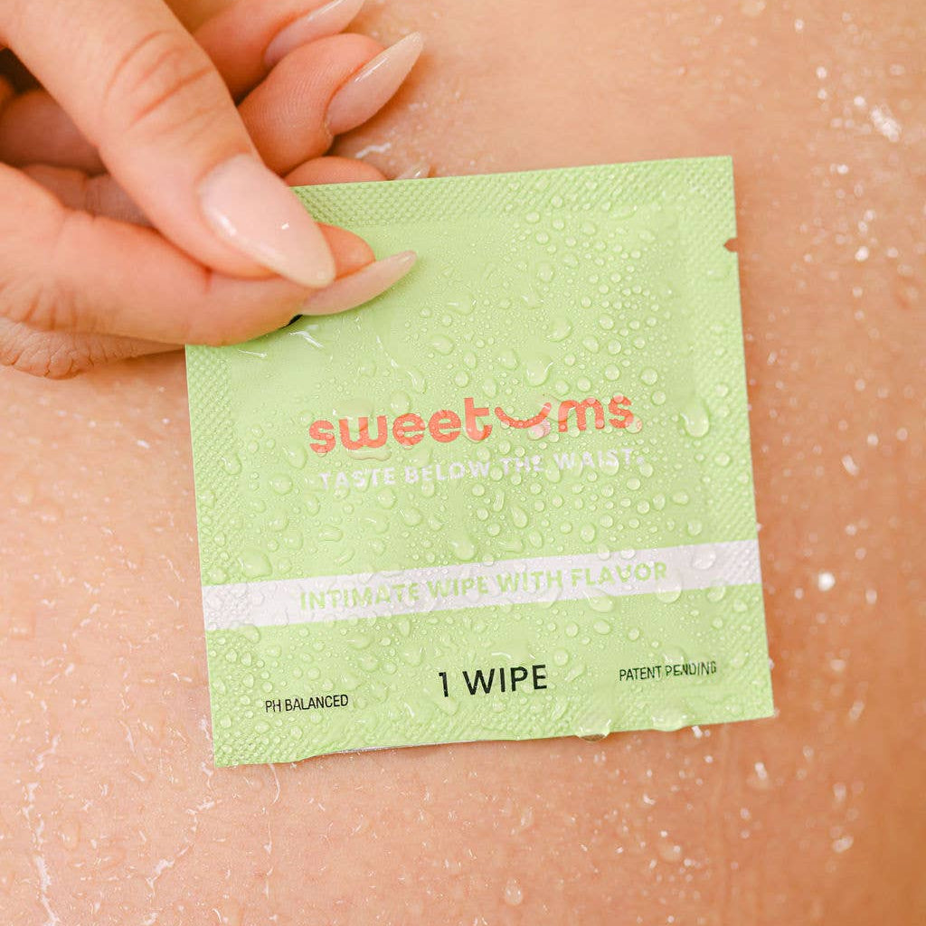 Green wipe labeled 'sweetums' being applied to skin