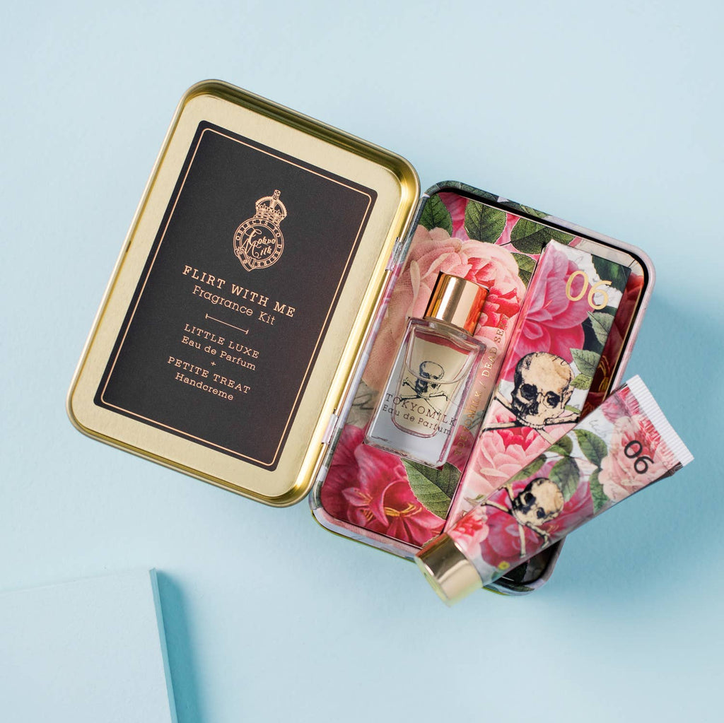 Perfume set with floral design on a light blue background