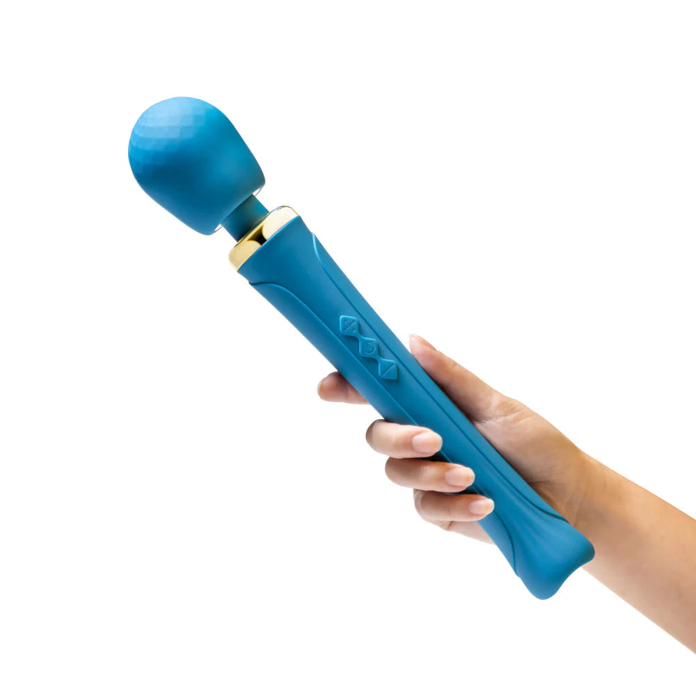 Blue handheld massager held by a hand on a white background