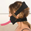 Side view of the gag, with a dildo facing out of the mouth hole and two secure straps holing it in pace behind the neck and at the top of her head.