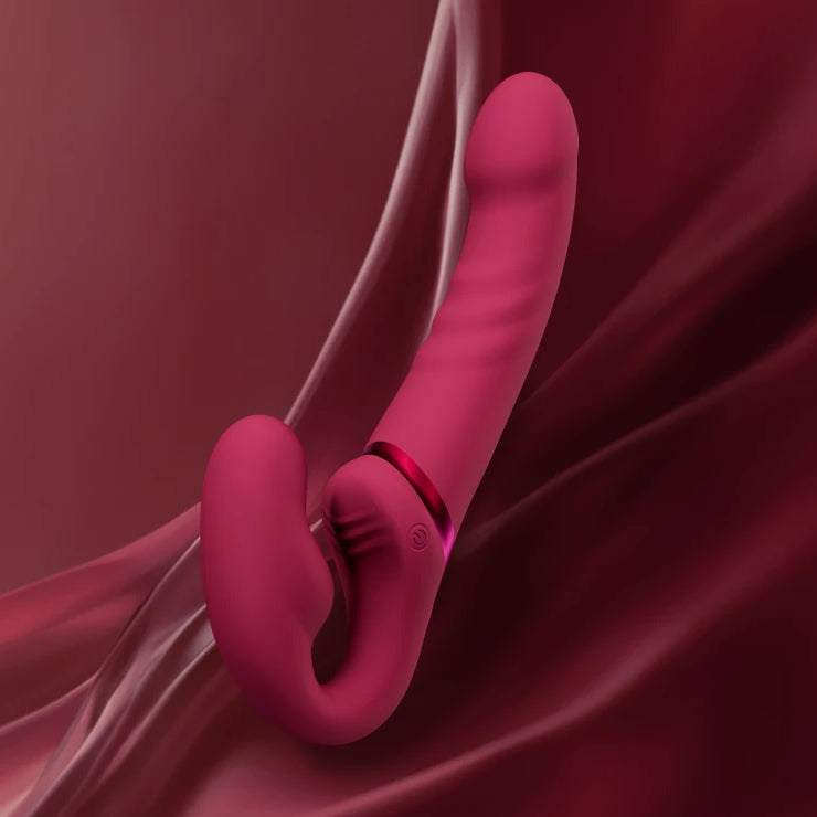 Pink ring-like object on a draped red fabric background