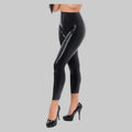 Black latex leggings with a high waist.