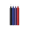 Four taper candles in black, blue, purple, and red, standing upright side by side on a plain white background.