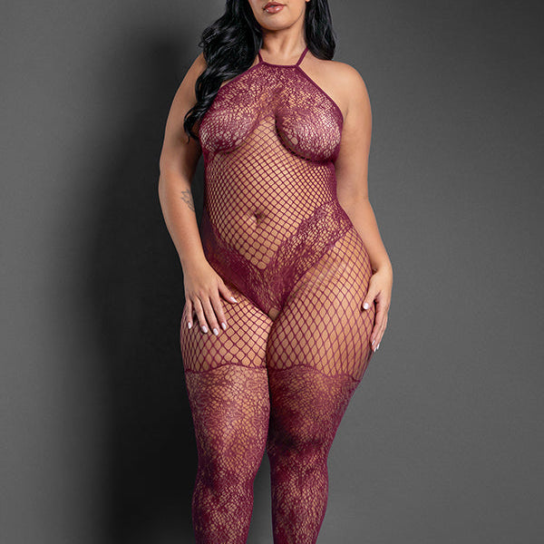 Woman wearing a red fishnet outfit against a gray background
