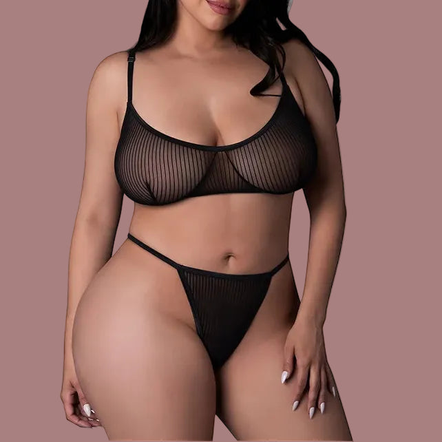 Woman wearing a black mesh lingerie set on a white background