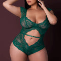 Woman wearing a green lace lingerie set against a dark background