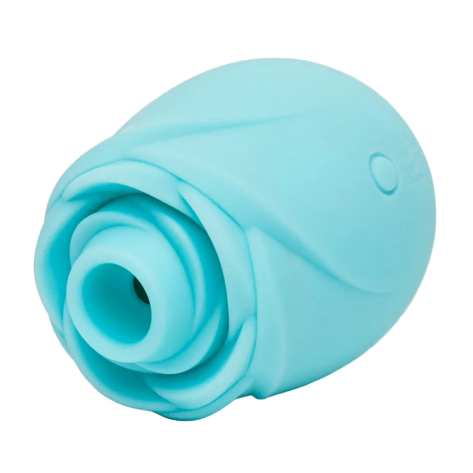 A light blue silicone personal massager with a rose-like textured exterior and a central opening, shown on a neutral light gray background.
