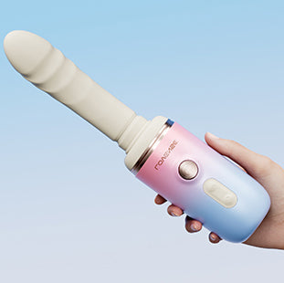 Hand holding the mechanical unit, with the Spinel dildo attachment on it.