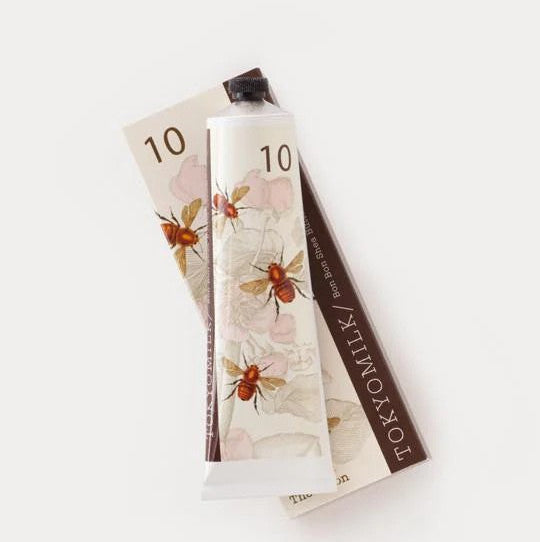 TOKYOMILK hand cream with floral design on a white background